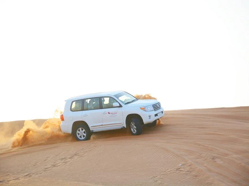 Dune Bashing in The Desert - Morning Safari with Camel Ride and Sand Boarding