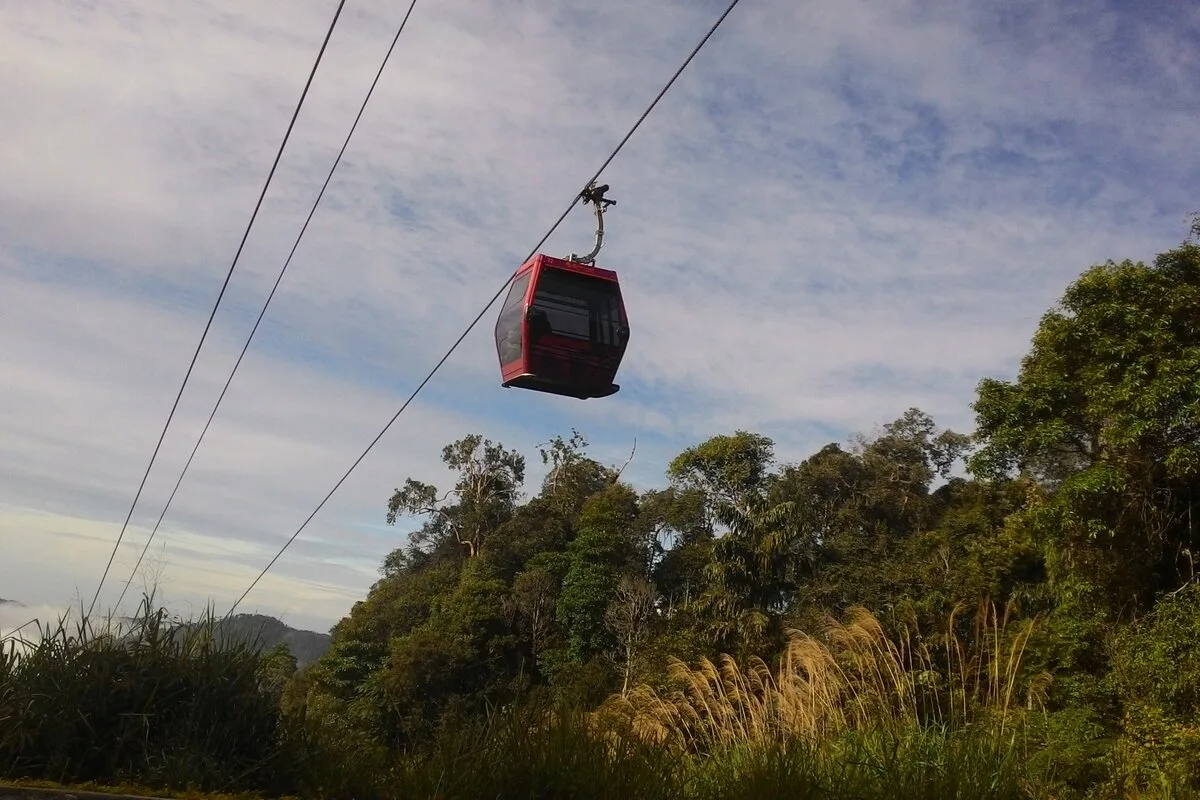 Awana SkyWay gondola cabin suspended above forest treetops at Genting Highlands