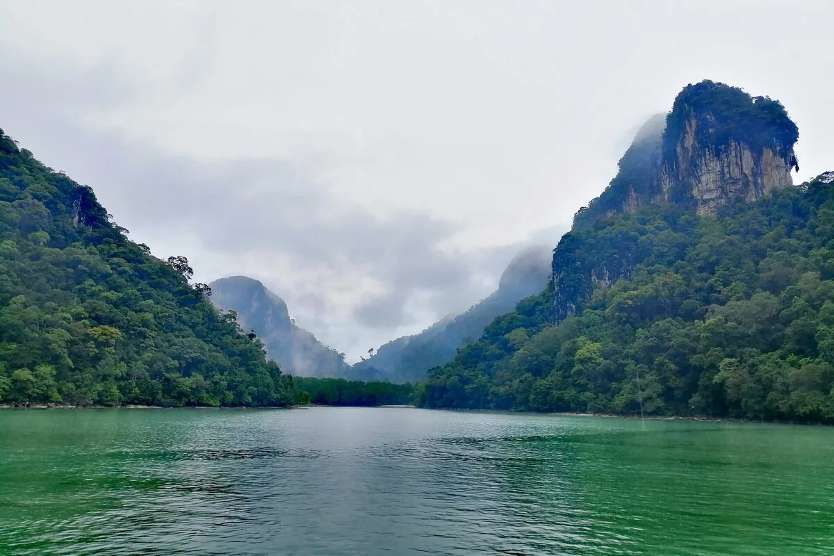 Limestone karst peaks of Dayang Bunting Island rising steeply above green water in Langkawi