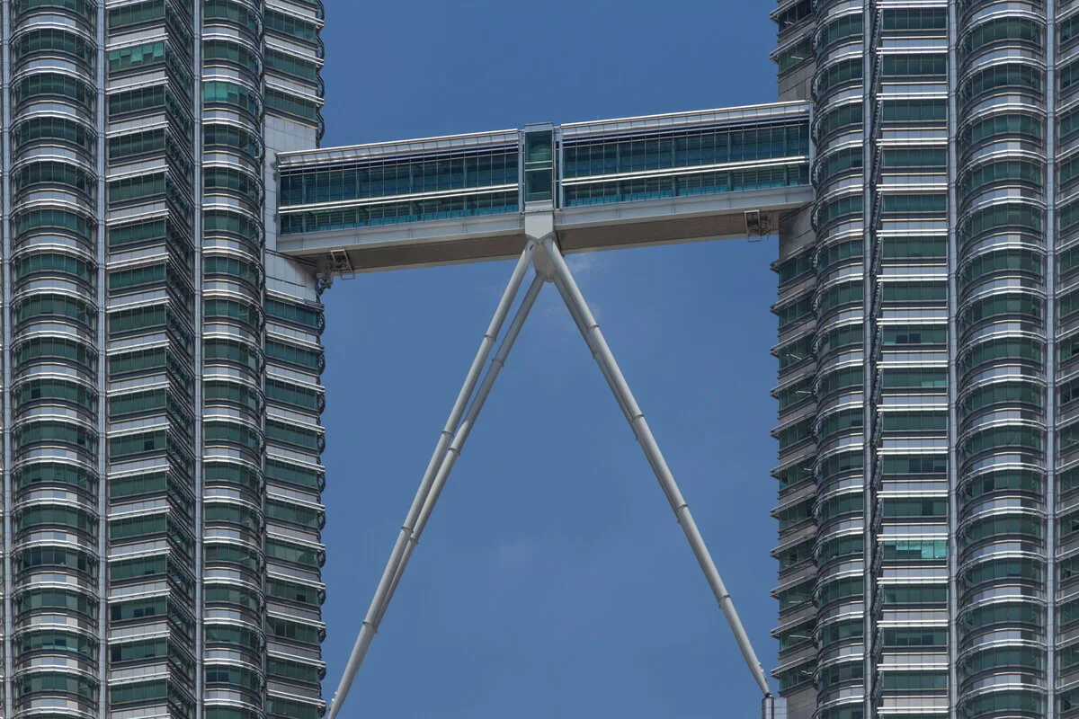 Close view of the Petronas Towers Skybridge linking the two towers against blue sky