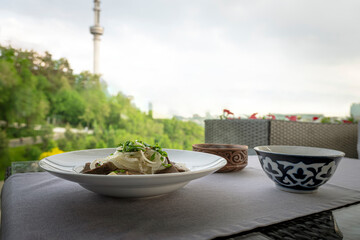 A delicious spread of traditional Kazakh dishes, including beshbarmak and kumis, showcasing Almaty's rich culinary delights.