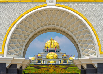 A majestic view of Putrajaya, Malaysia, featuring intricate Islamic architectural designs, golden domes, and beautifully landscaped surroundings.