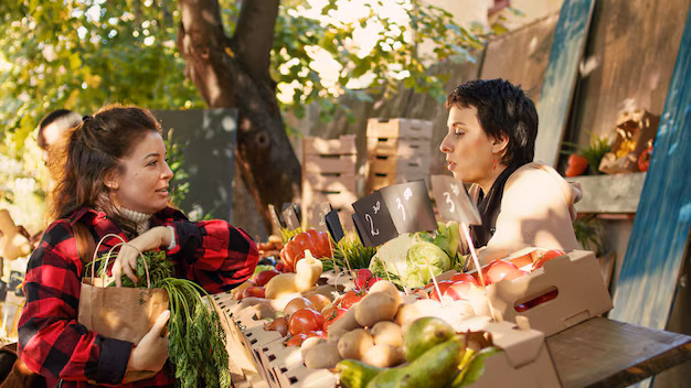 a girl purchase vegetables from   Green Bazaar in Almaty, showcasing vibrant market life with people shopping for fresh produce, handmade crafts, and local delicacies amidst colorful stalls and bustling activity.