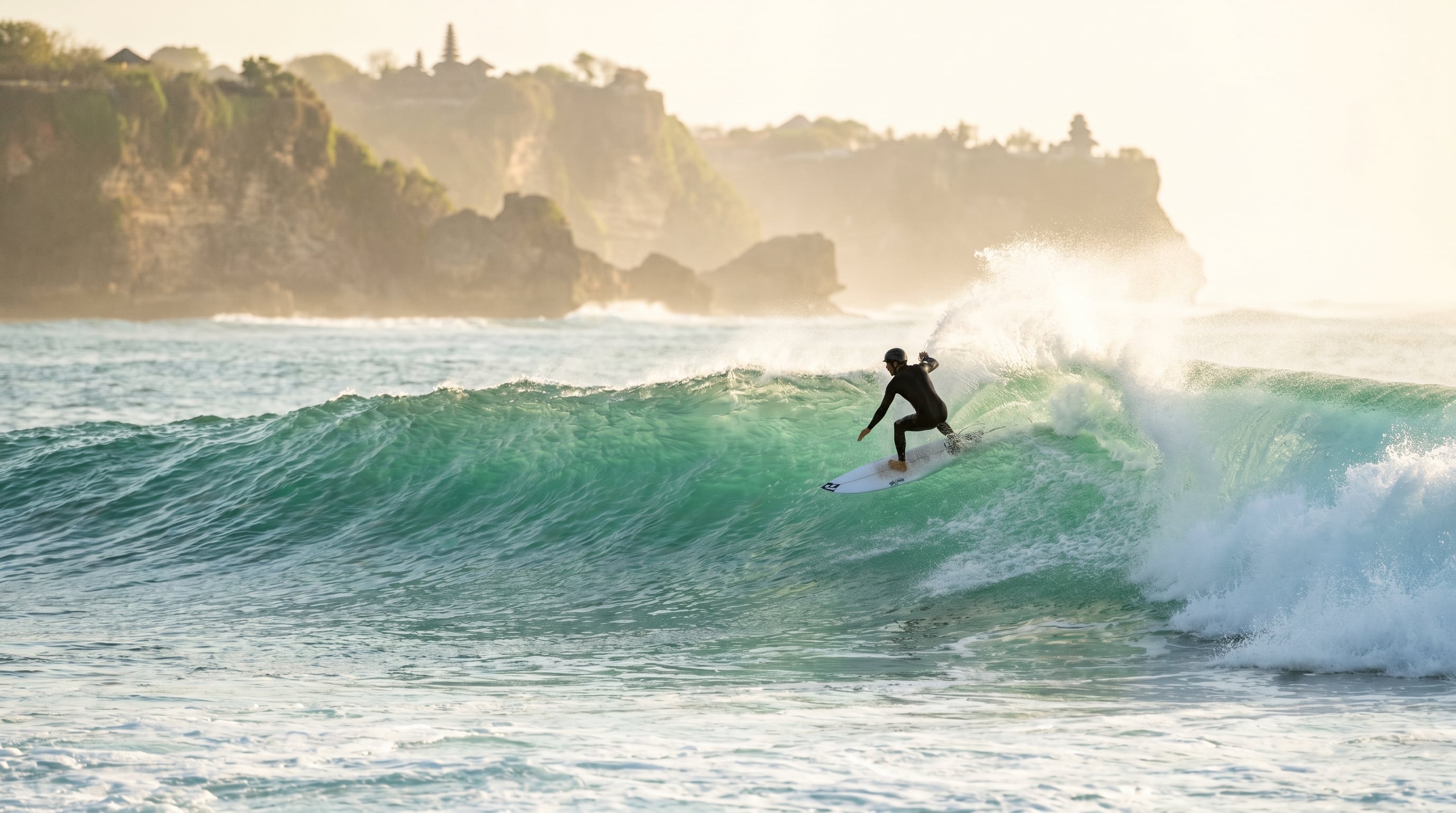 Surfer riding a wave at Uluwatu during the best time to visit Bali