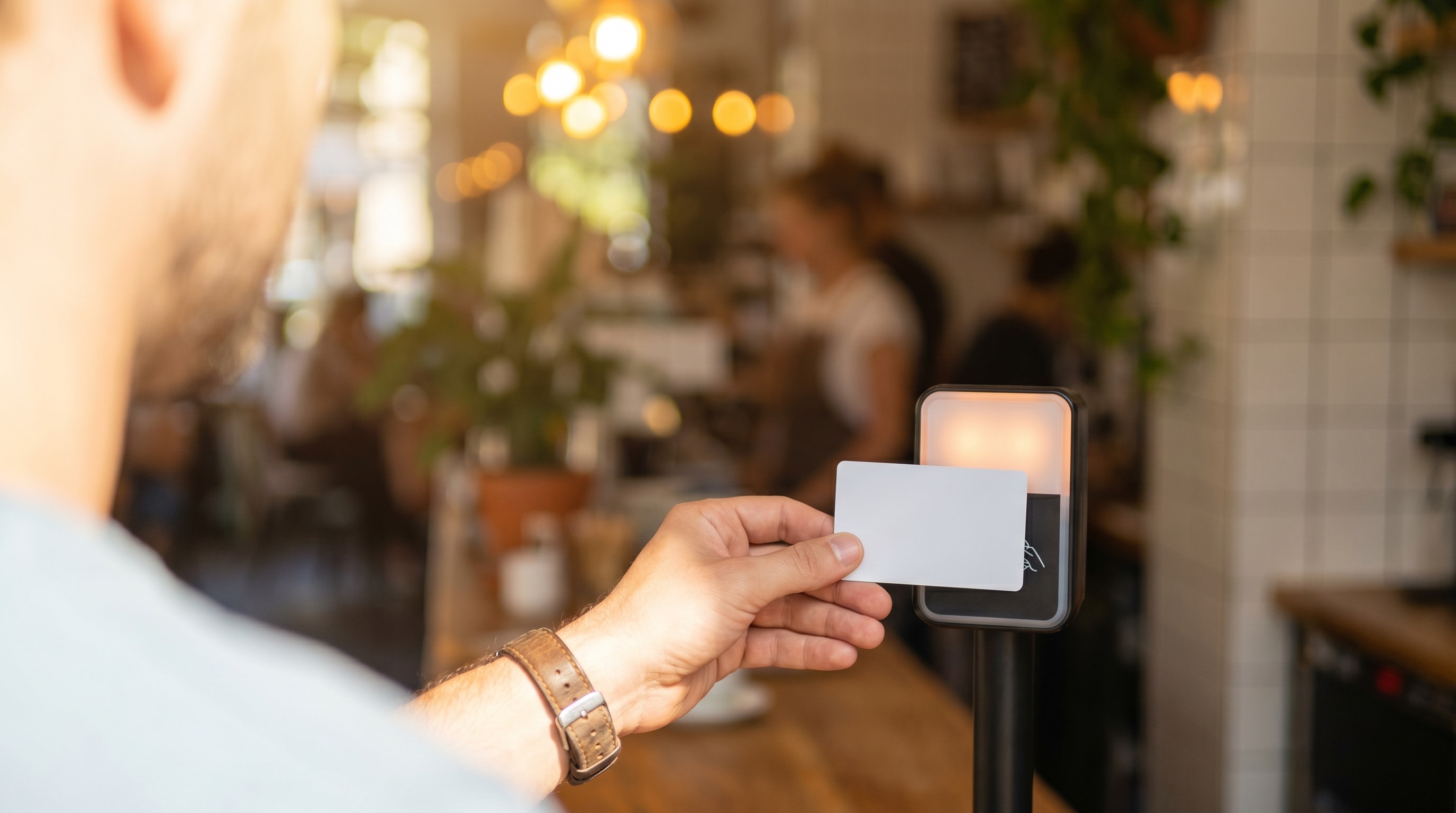 Traveller tapping a blank travel card at a foreign payment terminal