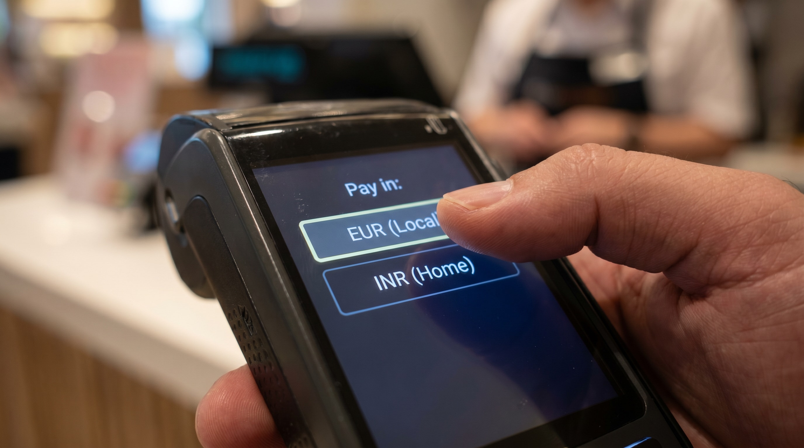 POS terminal showing the dynamic currency conversion choice between local currency and home currency