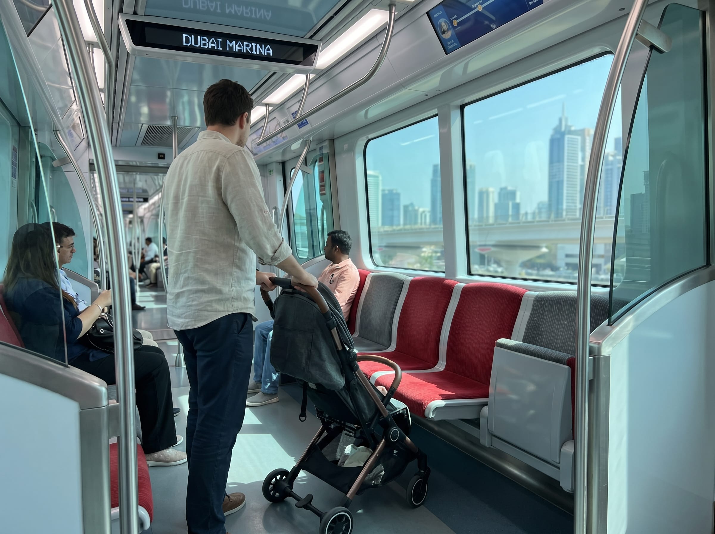 Parent with a stroller on the air-conditioned Dubai Metro, easy for Dubai with toddlers