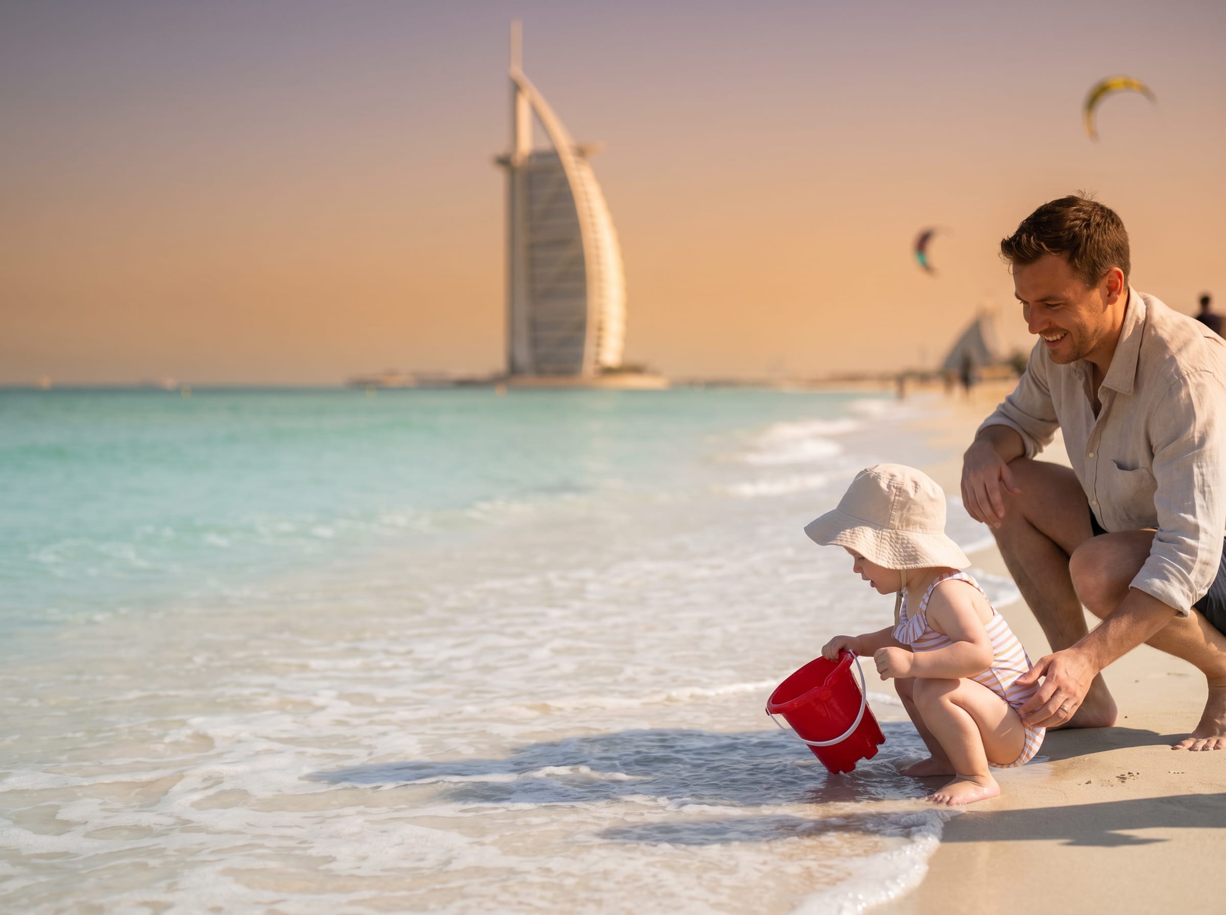 Toddler playing on Kite Beach with the Burj Al Arab behind, ideal in cooler months
