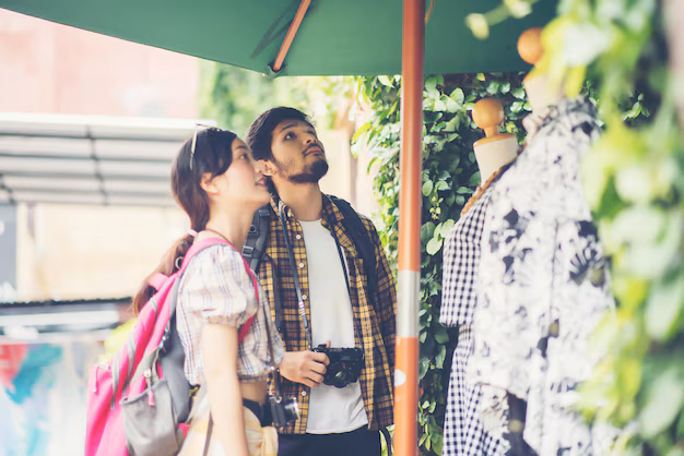 A cheerful couple shopping in Almaty's vibrant markets, surrounded by colorful stalls filled with local crafts and goods. This lively scene captures why Almaty should be your next holiday destination, offering unique shopping experiences, cultural immersion, and a blend of modern and traditional attractions.