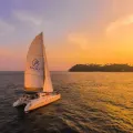 Coral Island and Sunset by Sailing Yacht Catamaran with Light Dinner - Half Day Tour