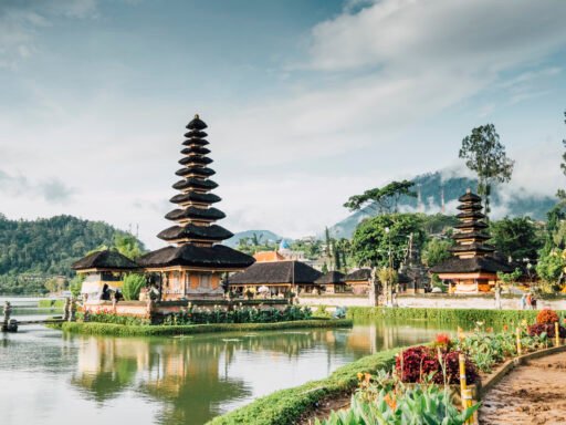 A traditional Balinese pagoda situated on a serene lake with mountains and lush greenery in the background. Best place to in visit Mauritius.