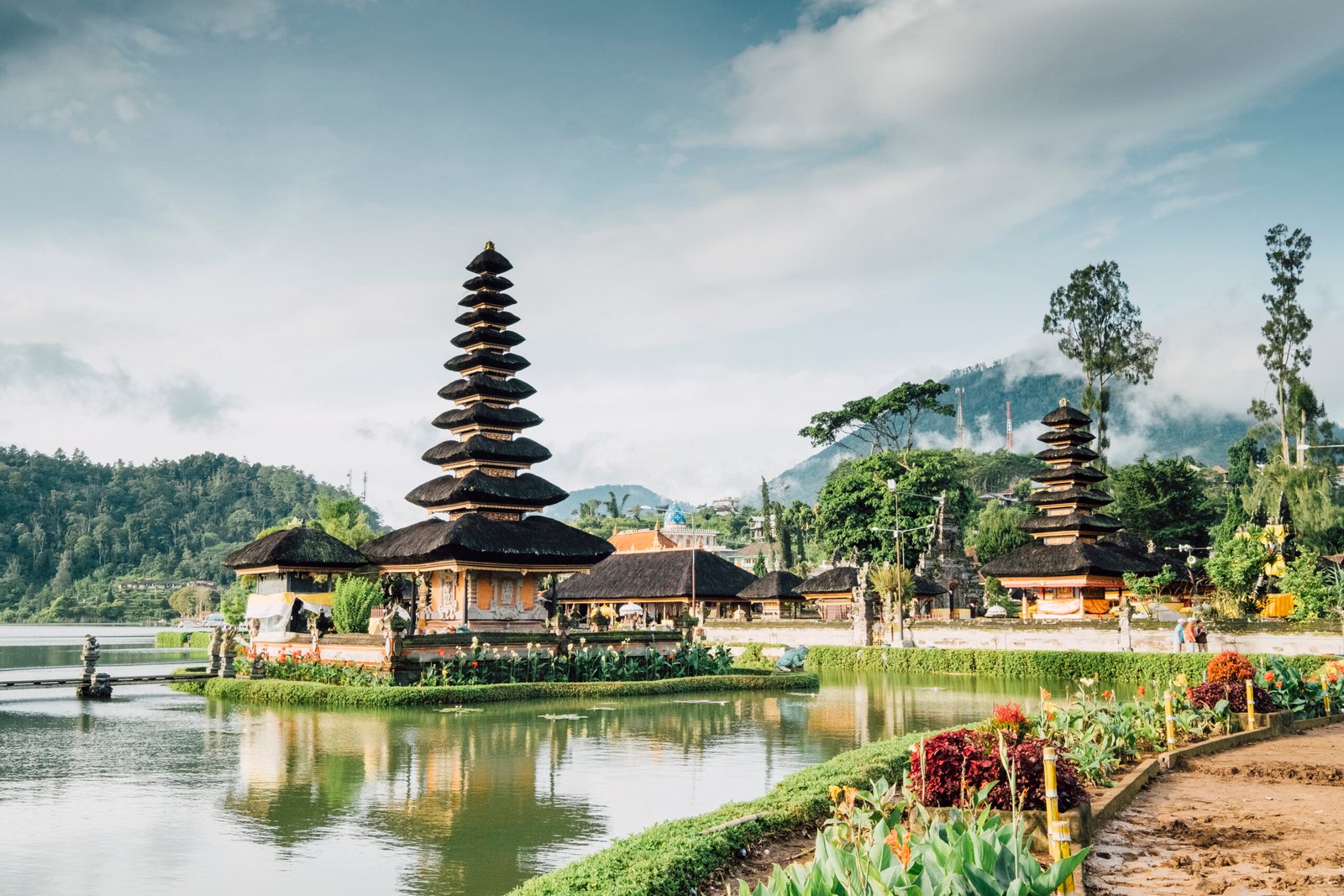 A traditional Balinese pagoda situated on a serene lake with mountains and lush greenery in the background. Best place to in visit Mauritius.