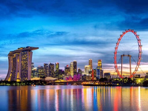 Marina Bay Sands and Singapore Flyer at twilight with city skyline reflection. 5 best places to visit in Singapore. Singapore tour package