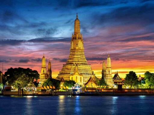 Wat Arun Temple illuminated at twilight in Bangkok, Thailand. best time to visit Thailand.