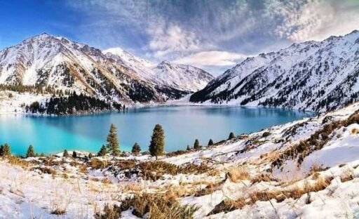 Big Almaty Lake surrounded by snow-capped mountains in the Tian Shan range during winter, featuring turquoise water and scenic landscapes picture Source: Pinterest