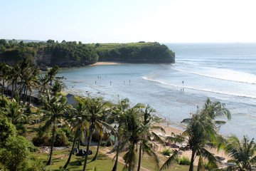 Balangan Beach in Bali is a serene escape with golden sands, stunning cliff-top views, and rolling waves, making it a paradise for surfers and nature lovers.