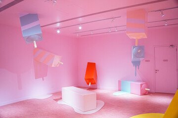 Colorful interior of the Ice Cream Museum in Singapore, featuring pink walls, melting popsicle sculptures, and playful design elements for visitors to enjoy.