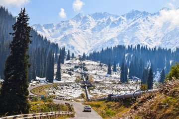 Almaty cityscape with snow-capped mountains, lush greenery, and urban landmarks symbolizing a warm welcome to Kazakhstan's vibrant hub.