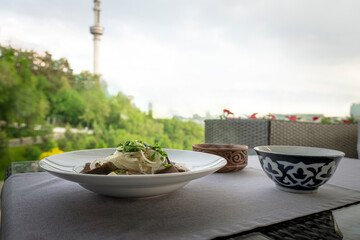 A delicious spread of traditional Kazakh dishes, including beshbarmak and kumis, showcasing Almaty's rich culinary delights.