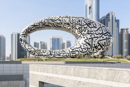 The iconic Museum of the Future in Dubai, a stunning oval-shaped architectural masterpiece adorned with intricate Arabic calligraphy. Surrounded by modern skyscrapers, this futuristic structure stands as a symbol of innovation and forward-thinking, reflecting Dubai’s vision for tomorrow.